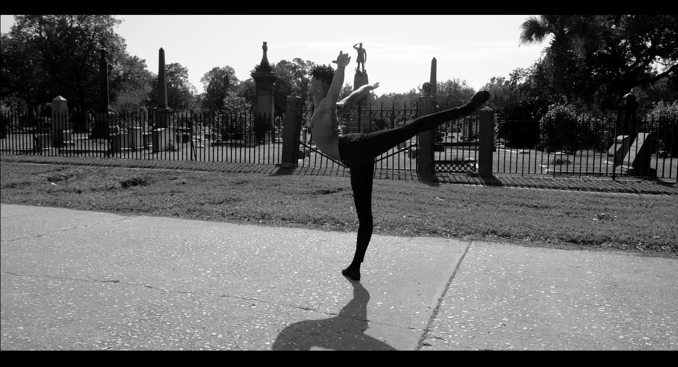 Maxfield Haynes strikes an arabesque in front of a graveyard
