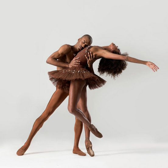 A duet between two DTH dancers. Both are dressed in all-brown.