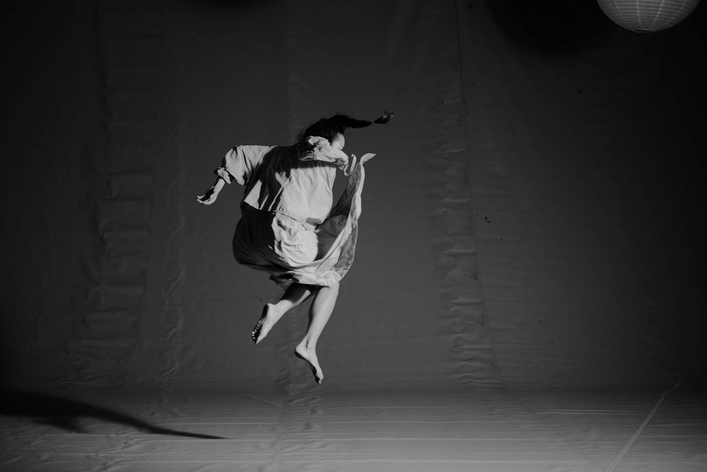Black and white photo of a girl jumping