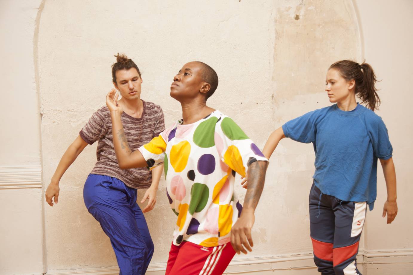 Three dancers in bright shirts