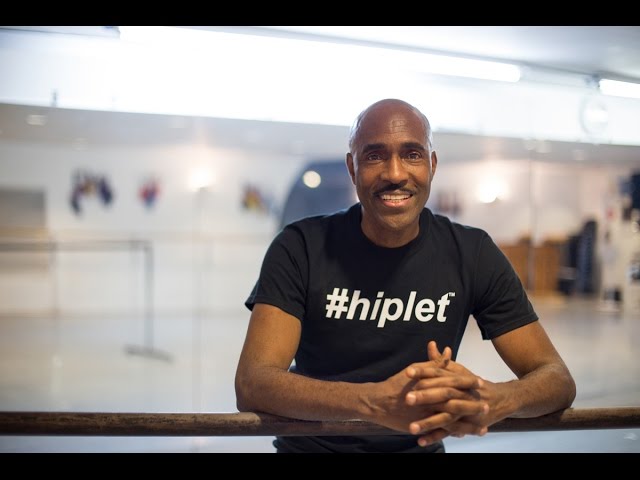 Homer Bryant in an empty dance studio  in a black t shirt with hiplet written in white across the front.