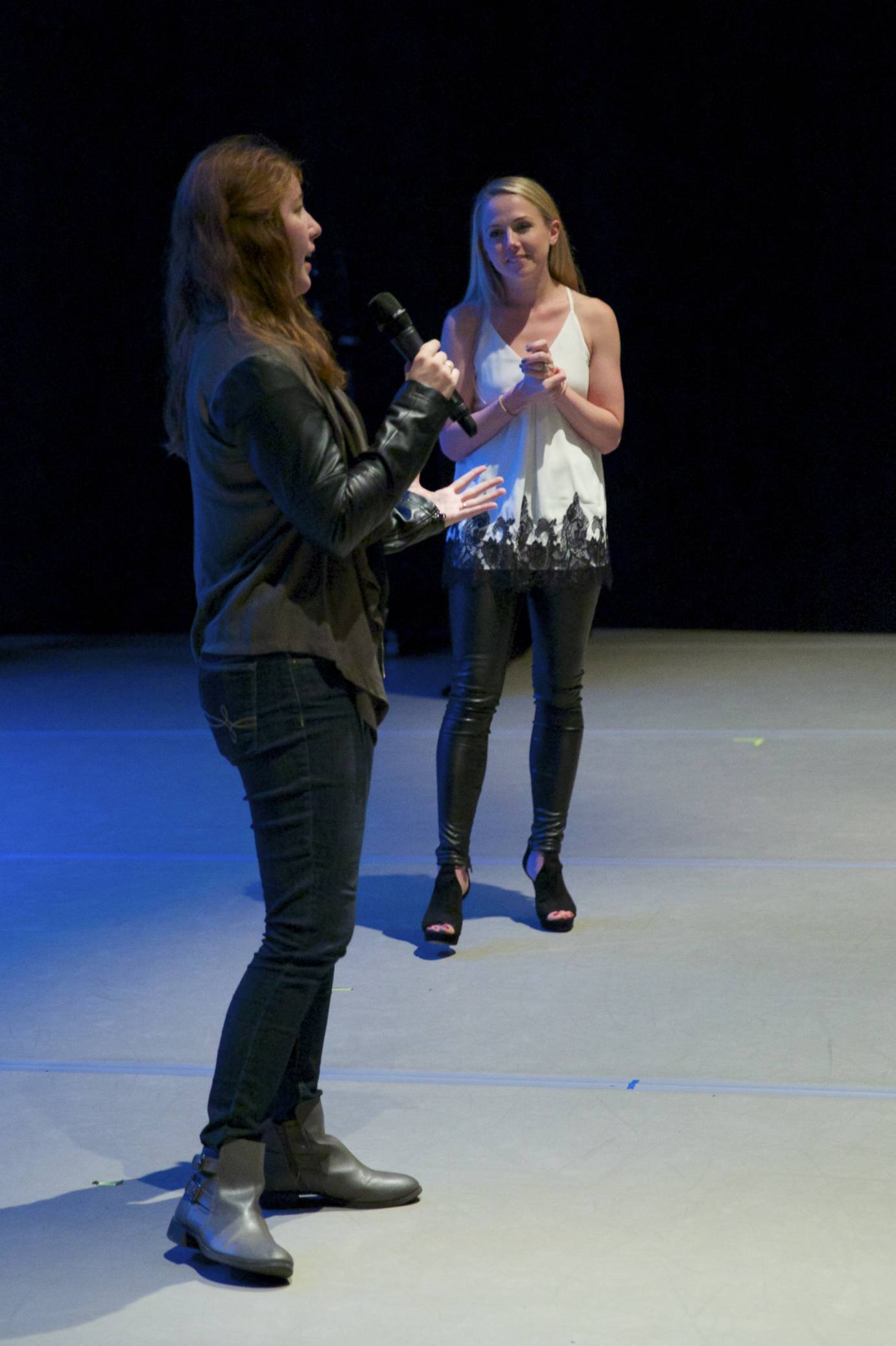 Two women stand on stage and talk about MorDance's performance