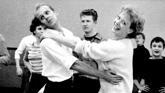 Black and white picture of Bob Fosse and Gwen Verdon loosely hugging.