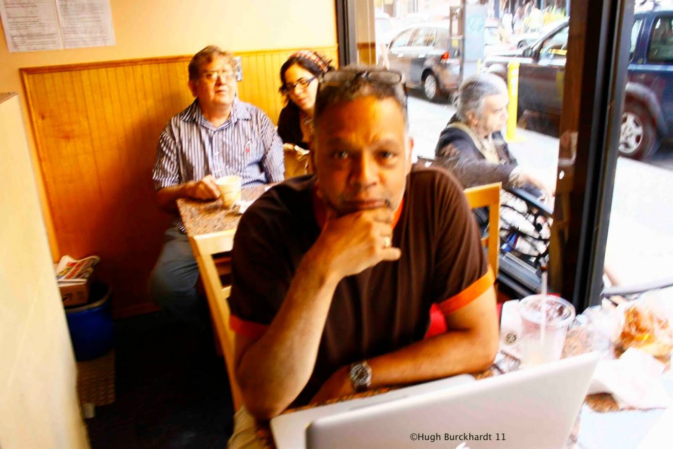 Ishmael Houston-Jones working on a laptop at a New York coffee shop.