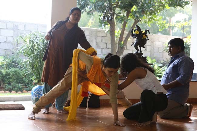 Anita Ratnam at home with her team: dramaturg, tailor and personal assistant. She is rehearsing her 5 costume changes for Faces... blessed unrest.  The work premiered at the Krishna Gana Sabha Theater in Chennai on December 28, 2007.