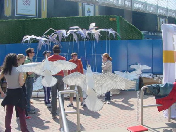 Dancers gather around the doves to rehearse entrances