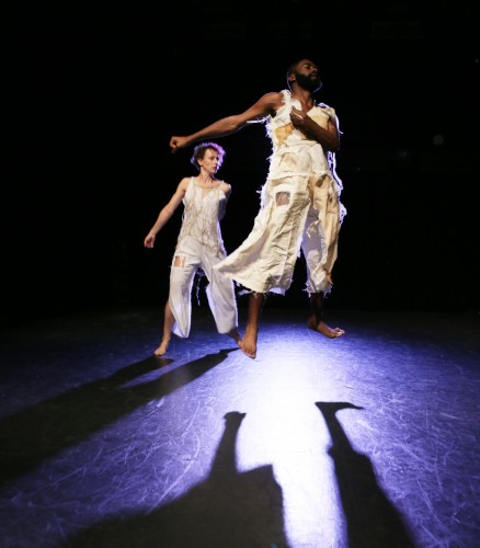 Two dancers jump with flexed feet