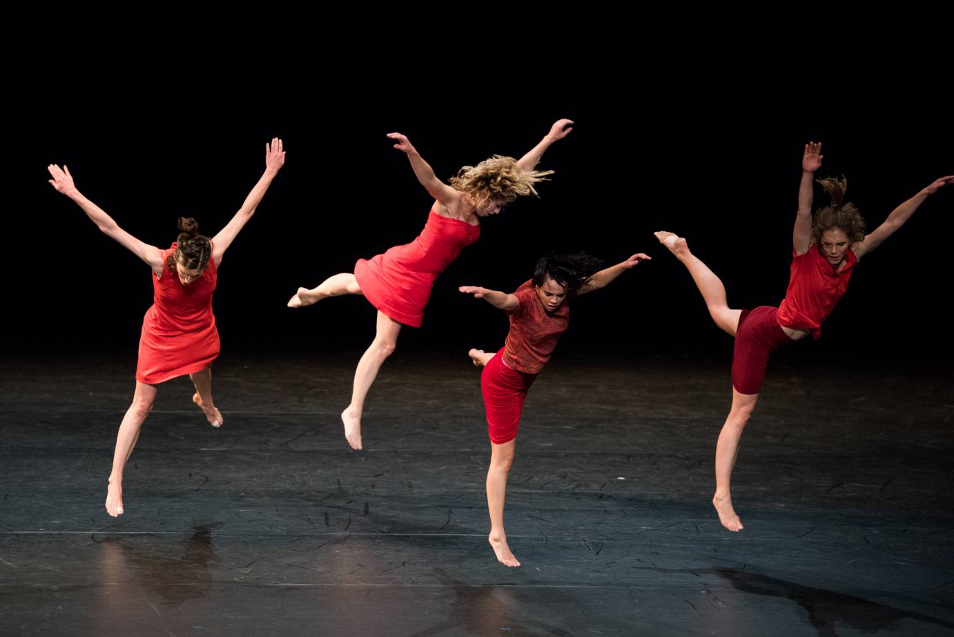 Women in red jump, arms in a V