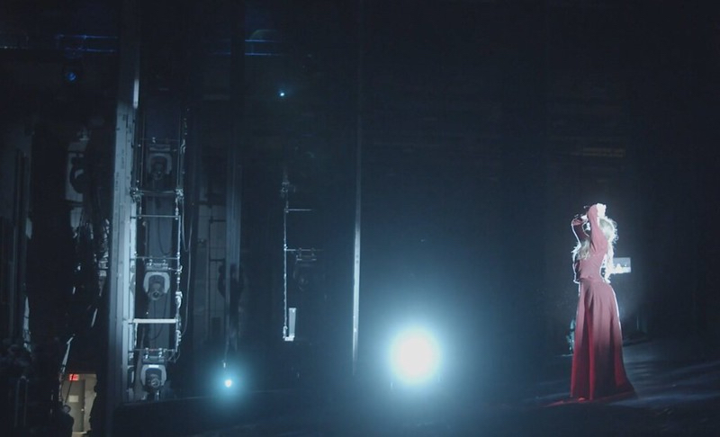 Alison Clancy performs on the Met stage in a red dress