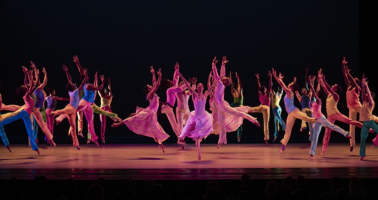 the stage is crowded with Ailey Company dancers and students of the school ...it is a colorful leaping mass, together in bright unison