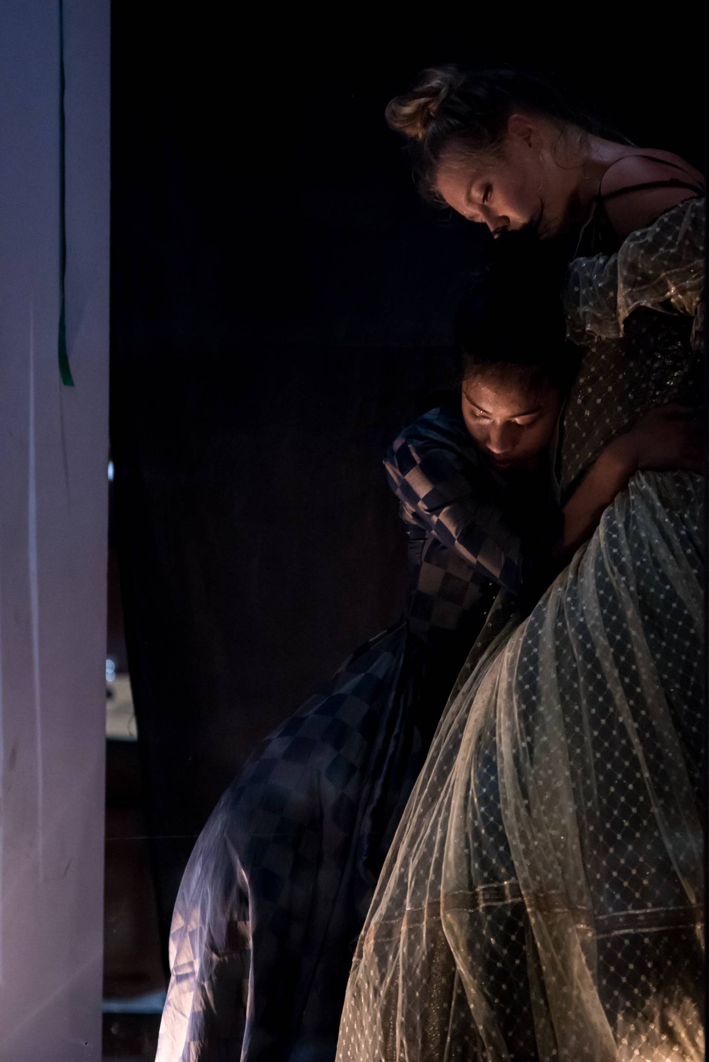 Two women crouch together