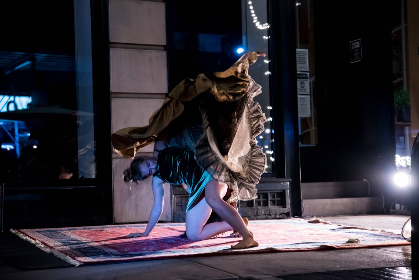 A woman thrashes as her gold dress hovers above her head