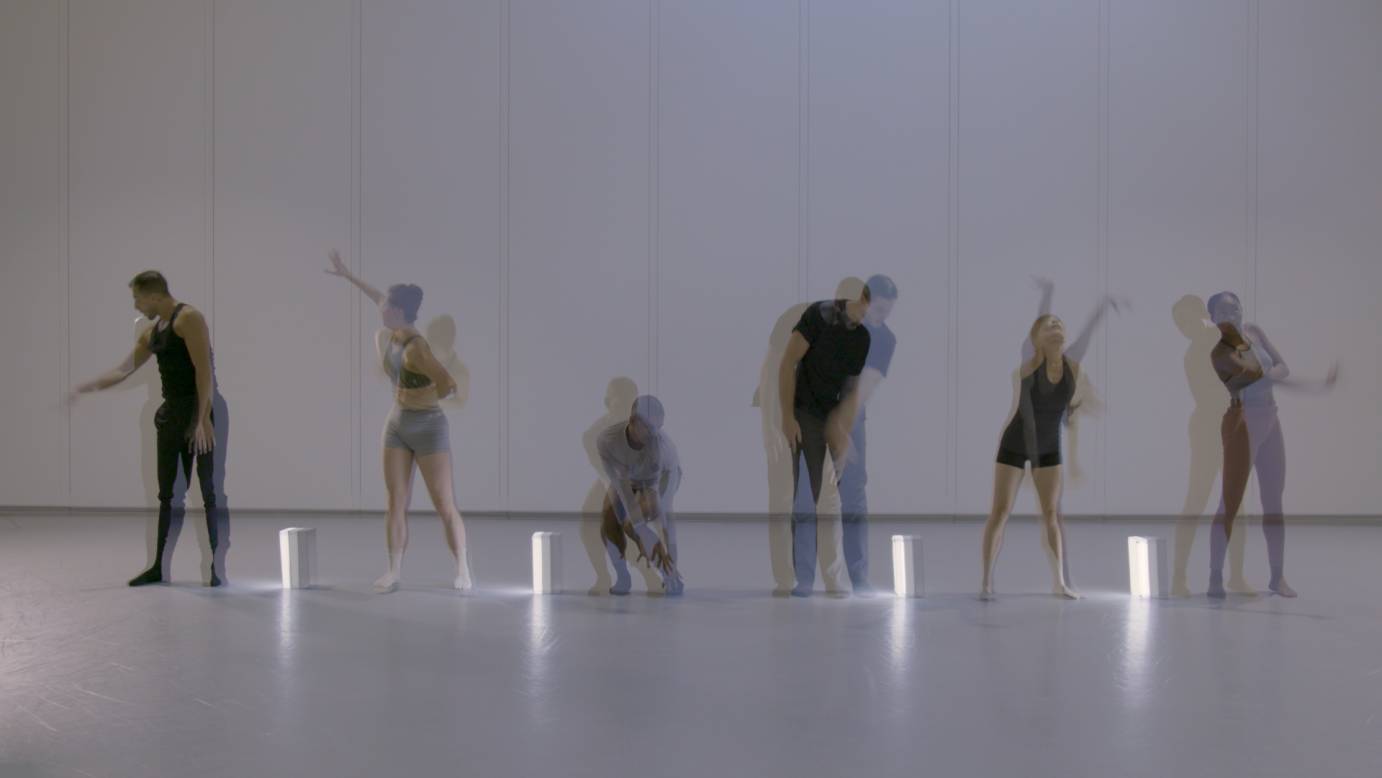six dancers their images blurred dance in a white room with boxes of light at their feet THAW by Francesca Harper