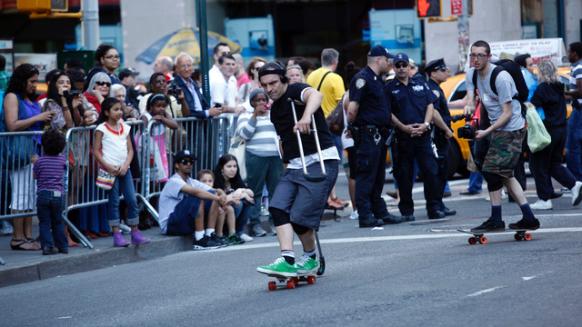 Bill Shannon on skateboard as people watch on the sidelines