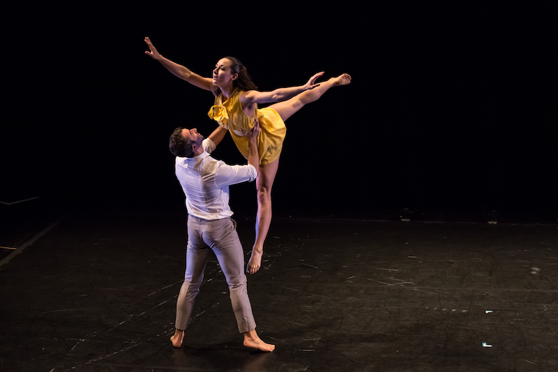 A man picks up a woman in yellow dress