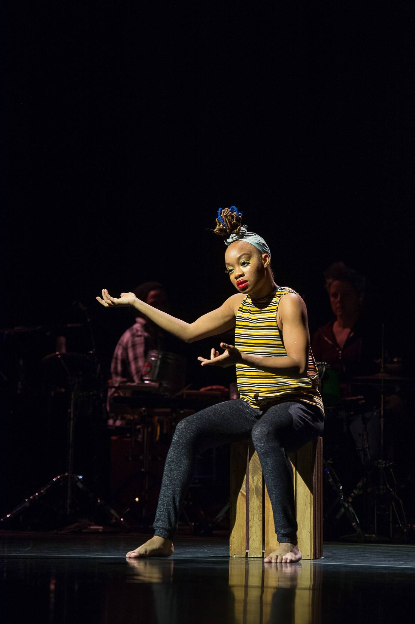 Camille A. Brown dancing in a chair