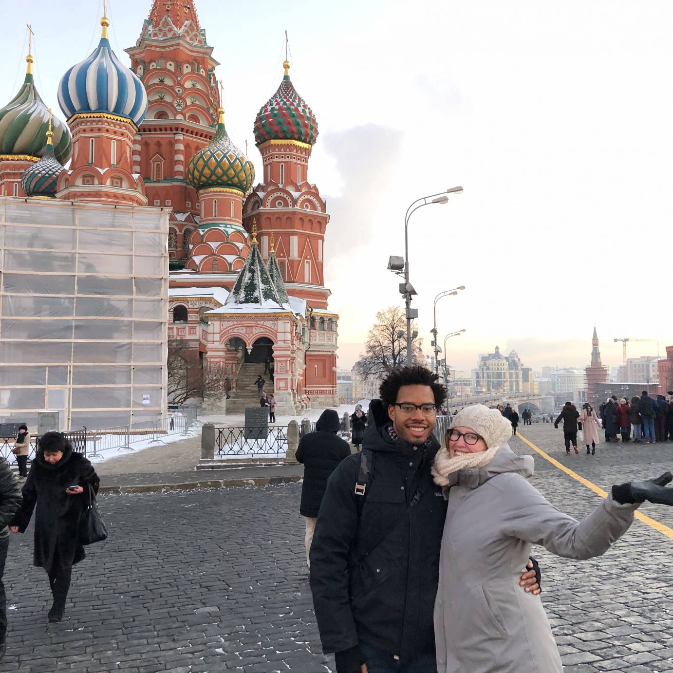 Carissa Landes and her husband, dressed in heavy coats, pose in front of St. Basil's