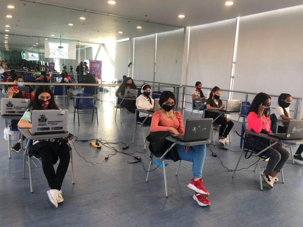 Girls sit behind laptops as part of Vive Bailando's STEM and dance initiative