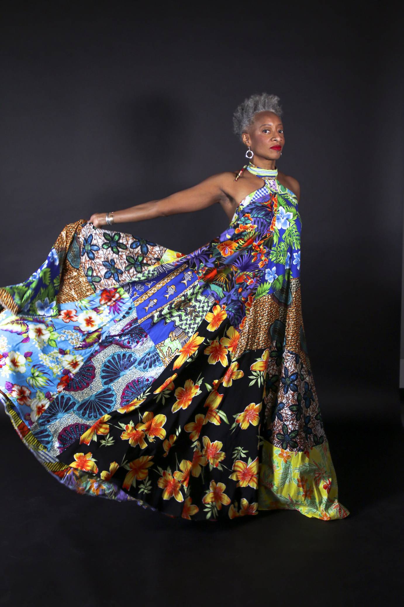 striking black woman in multi colored halter dress, grey and black afro, red lips,long earring, Cynthia Oliver  