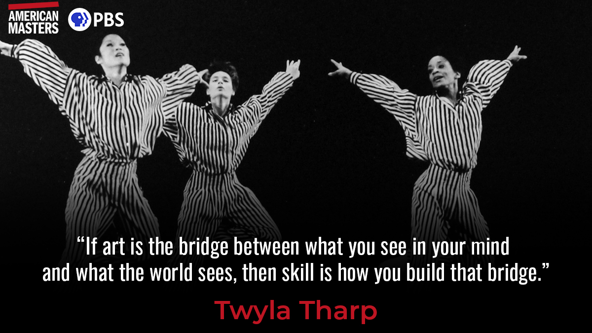 Picture of three women, their thrown arms up, in striped jumpsuits