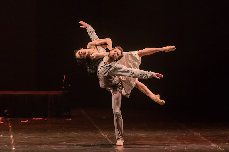 Oleg Gabyshev, the dancer playing Tchaikovsky, balances Lyubov Andreyeva, his female counterpart, across his back. They both look pleadingly out to the audience.