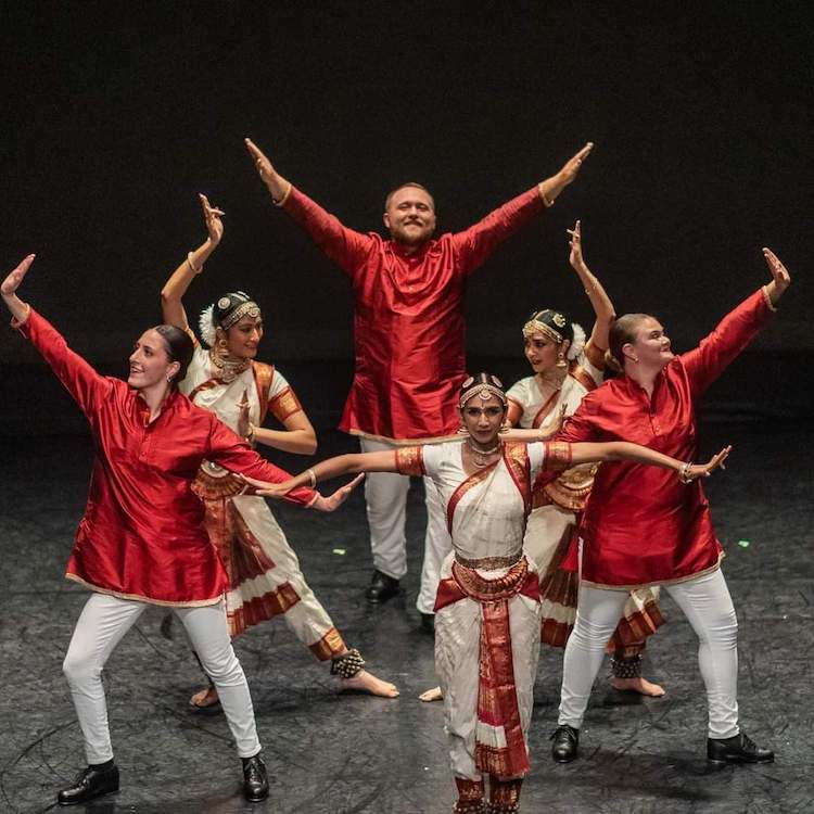 tap dancers and classical Indian dancers mix it up on stage...3 dressed in traditional Indian garb and three wearing red silk tunic, white jeans, and black tap shoes. All are joyful.