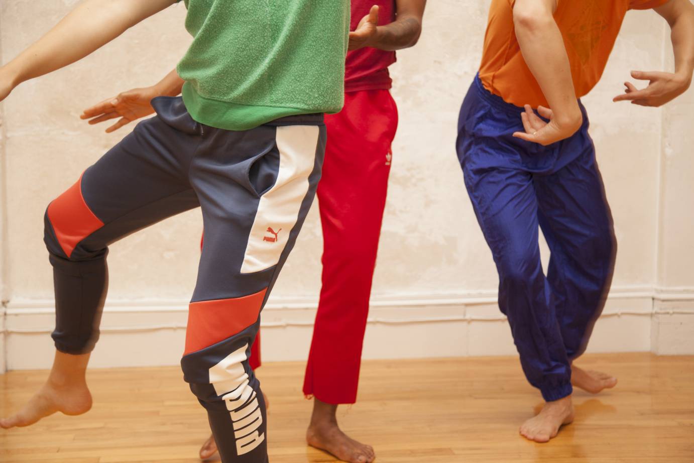 Legs of dancers in colorful pants