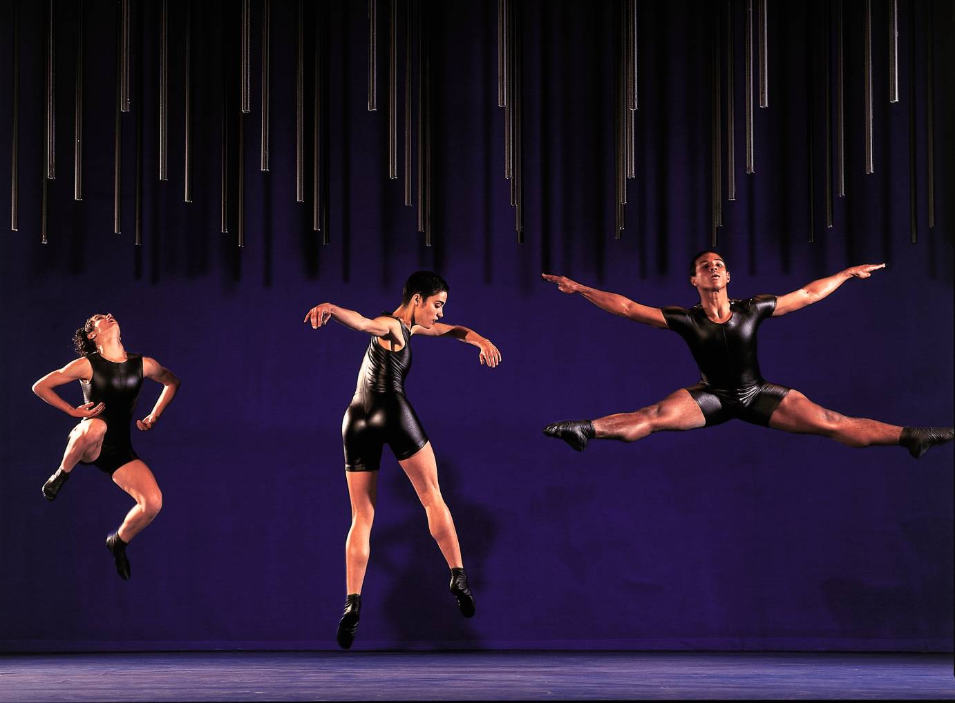 Dancers leap across the stage