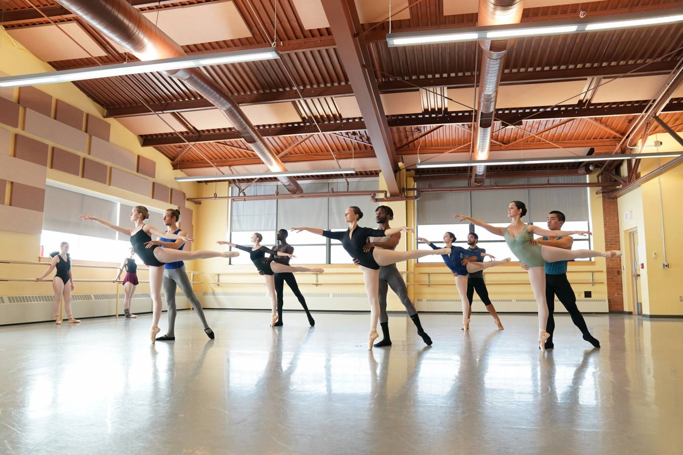 A pas de deux class in which men partner women in first arabesque