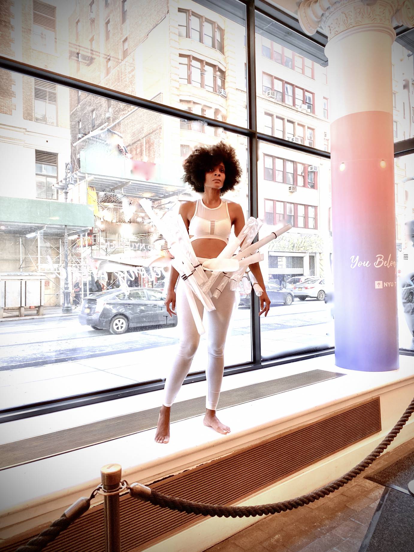 women in window with bubbles and tubes at her waist