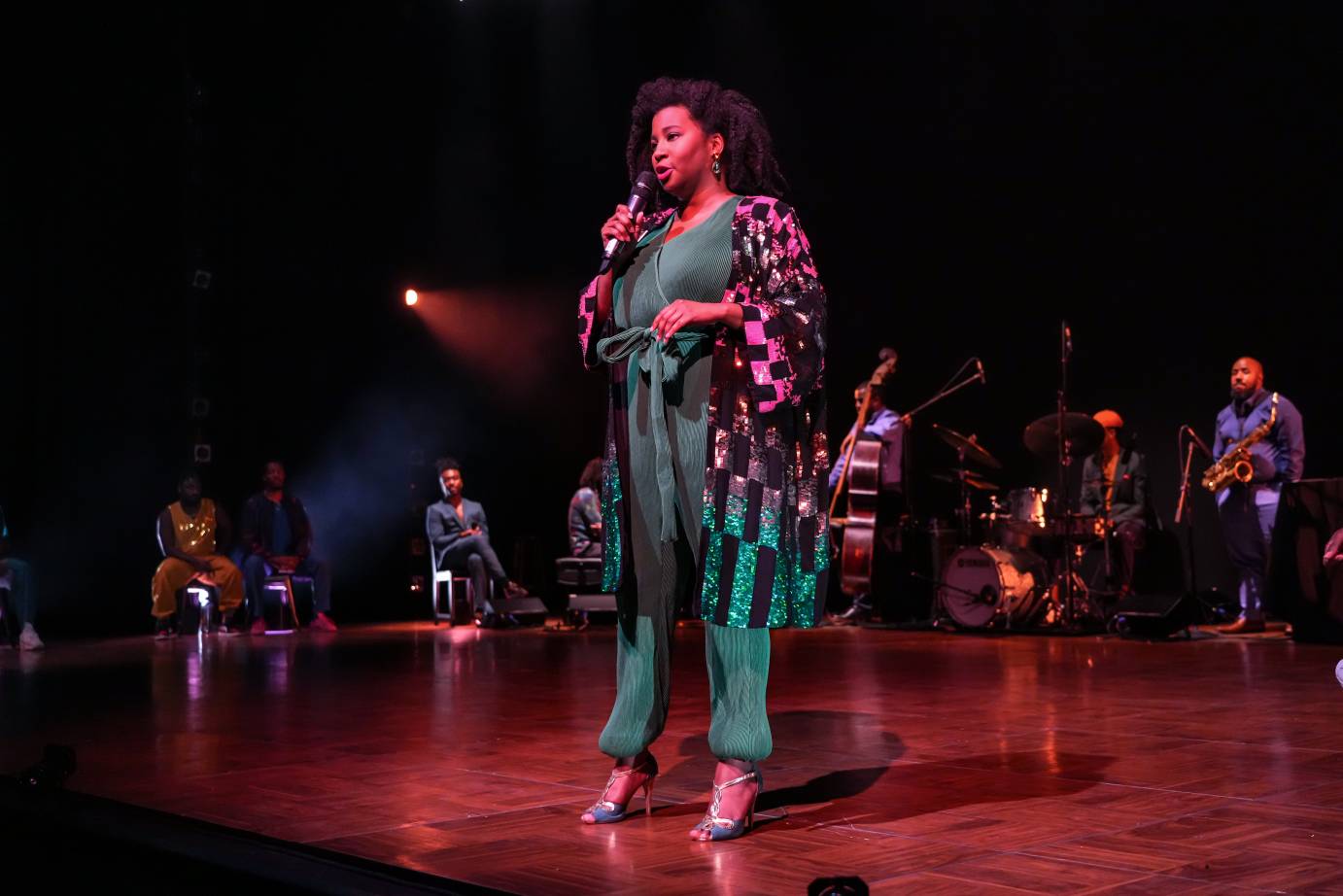 melanie george in green jump suit,green glittery jacket, and sparkly shoes