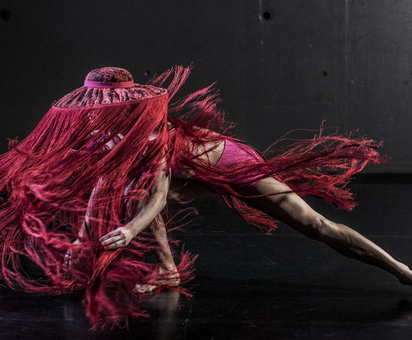 A woman in a hat with fringe lunges