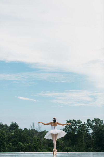 Christine Shevchenko in a backbend against a beautiful backdrop of trees and sky