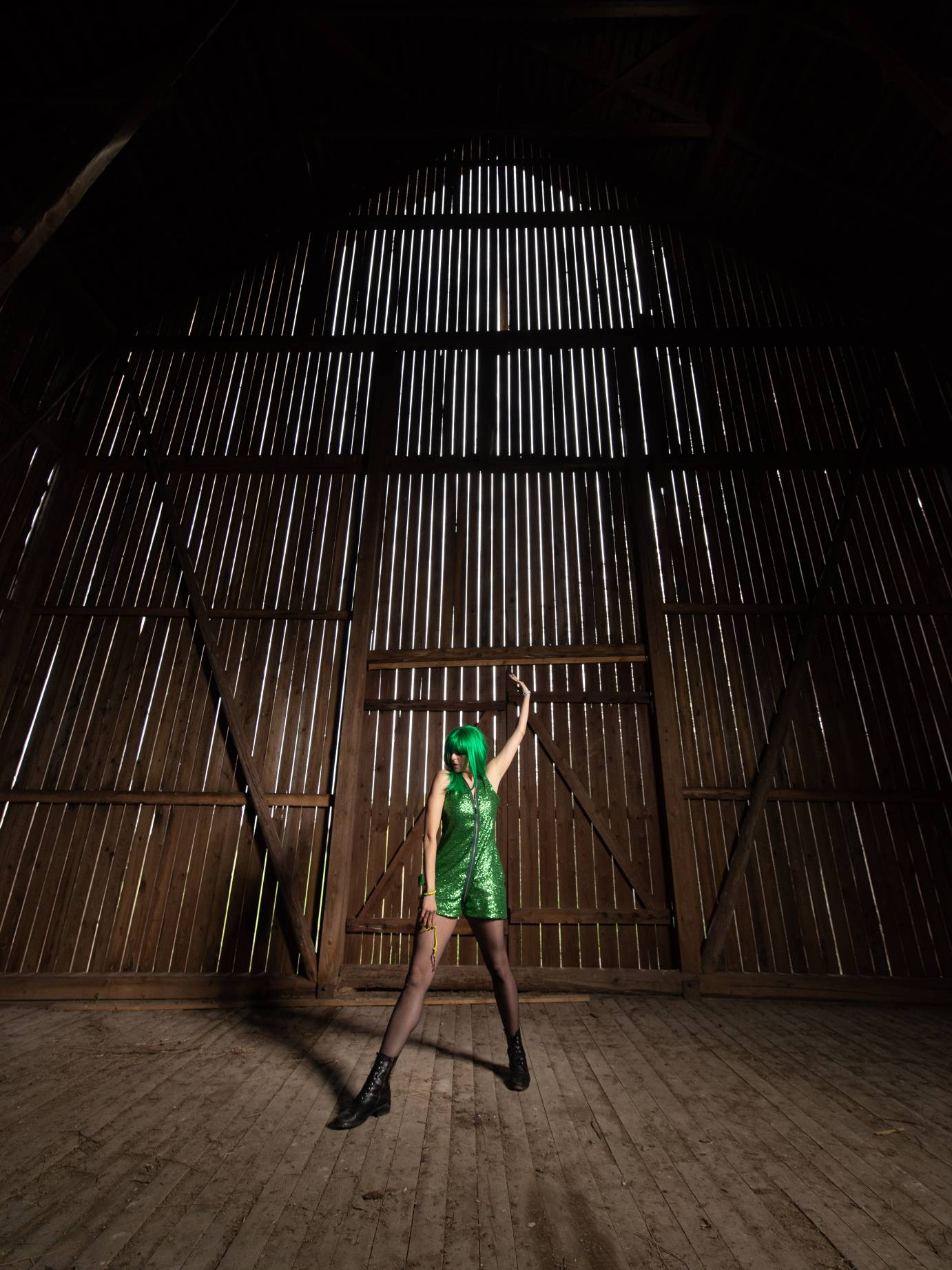 A woman sports a green wig and green shorty-tard