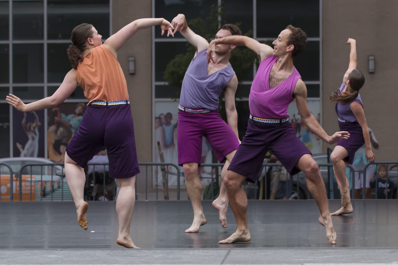 a dance conversation where jumping dancers lean in to a circel