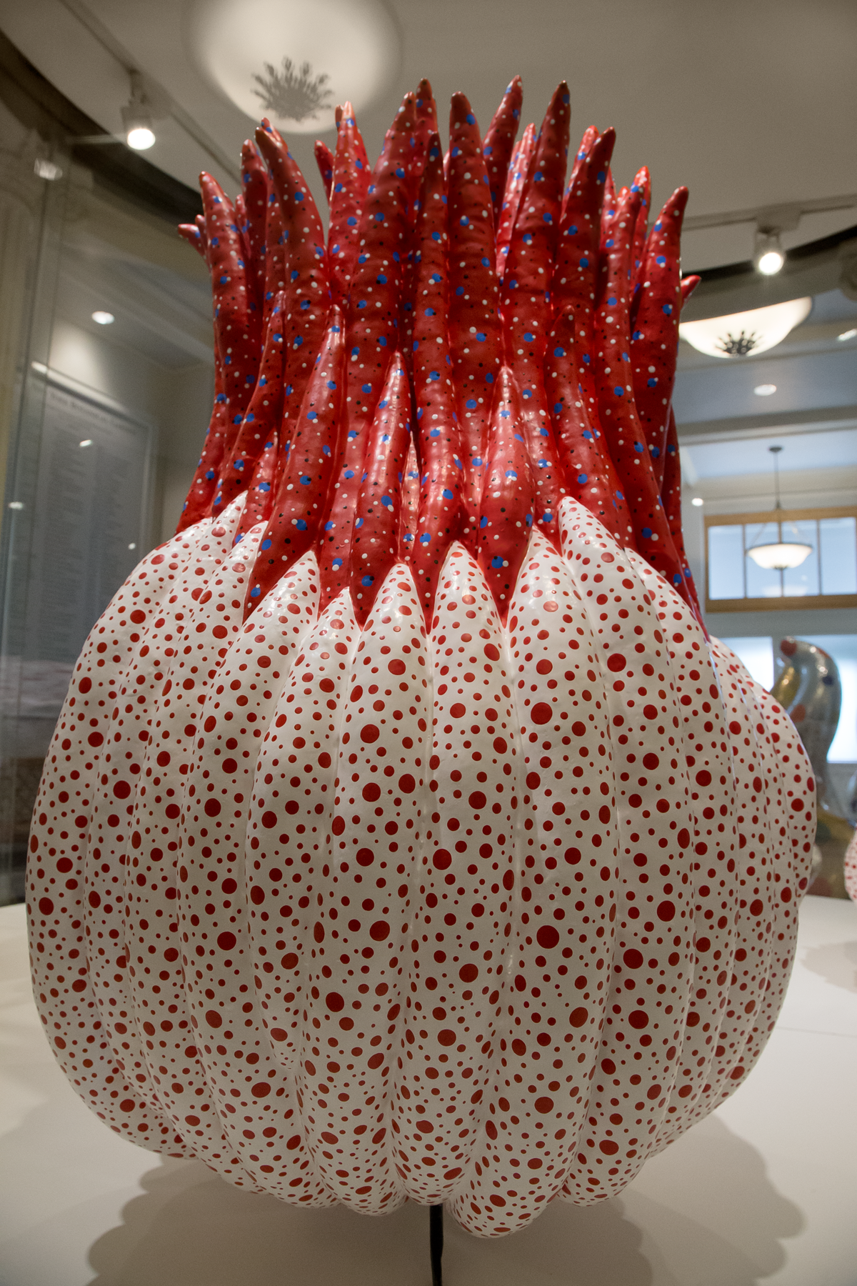 this gourd with hair .. a huge white bodied, red haired gourd dotted with multitudes of polka dots mirrors the upward extension of the dancers in the previous picture