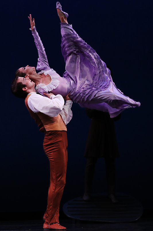 the husbandman flings his future bride into the air. the couple are in profile.  Her upper body appears to be resting on his chest as she soars upward above the ground