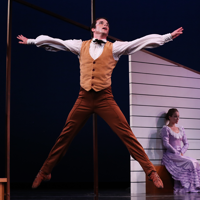 The bride sits quietly and introspectively as her Husband man dances in front of her, possibly discussing in choreography his plans for their new life. Here he jumps as if in the midst of a huge jumping jack.