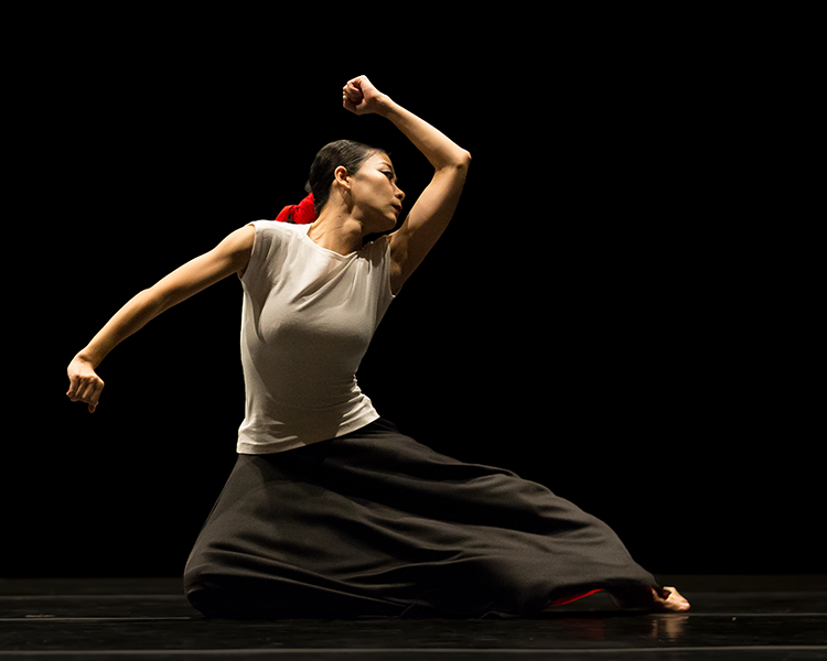 the dancers angles are apparent. The angle of her bent knees on the floor, theright angle of her left arm bent as if she will use her hand to hammer something.