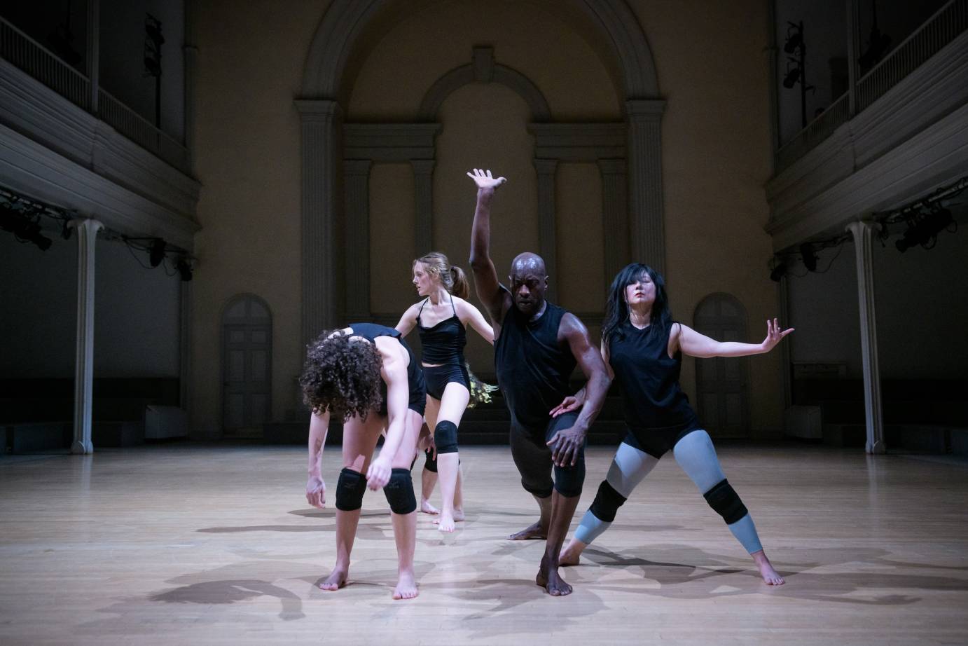 Dancers fling their chests forward