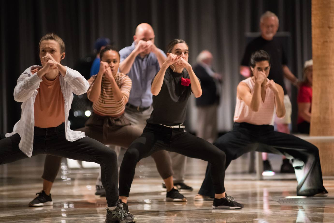 Dancers have their arms up like boxers