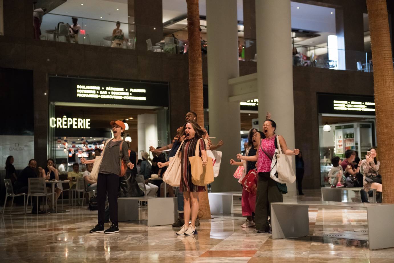 Men and women scream in a food court