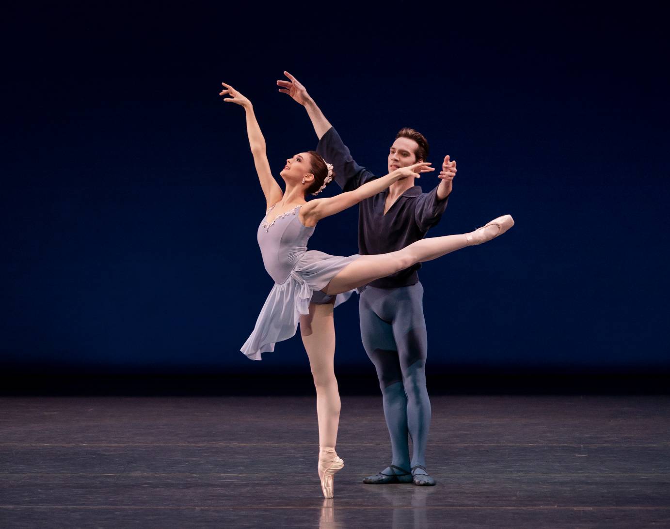 A man partners a woman in arabesque