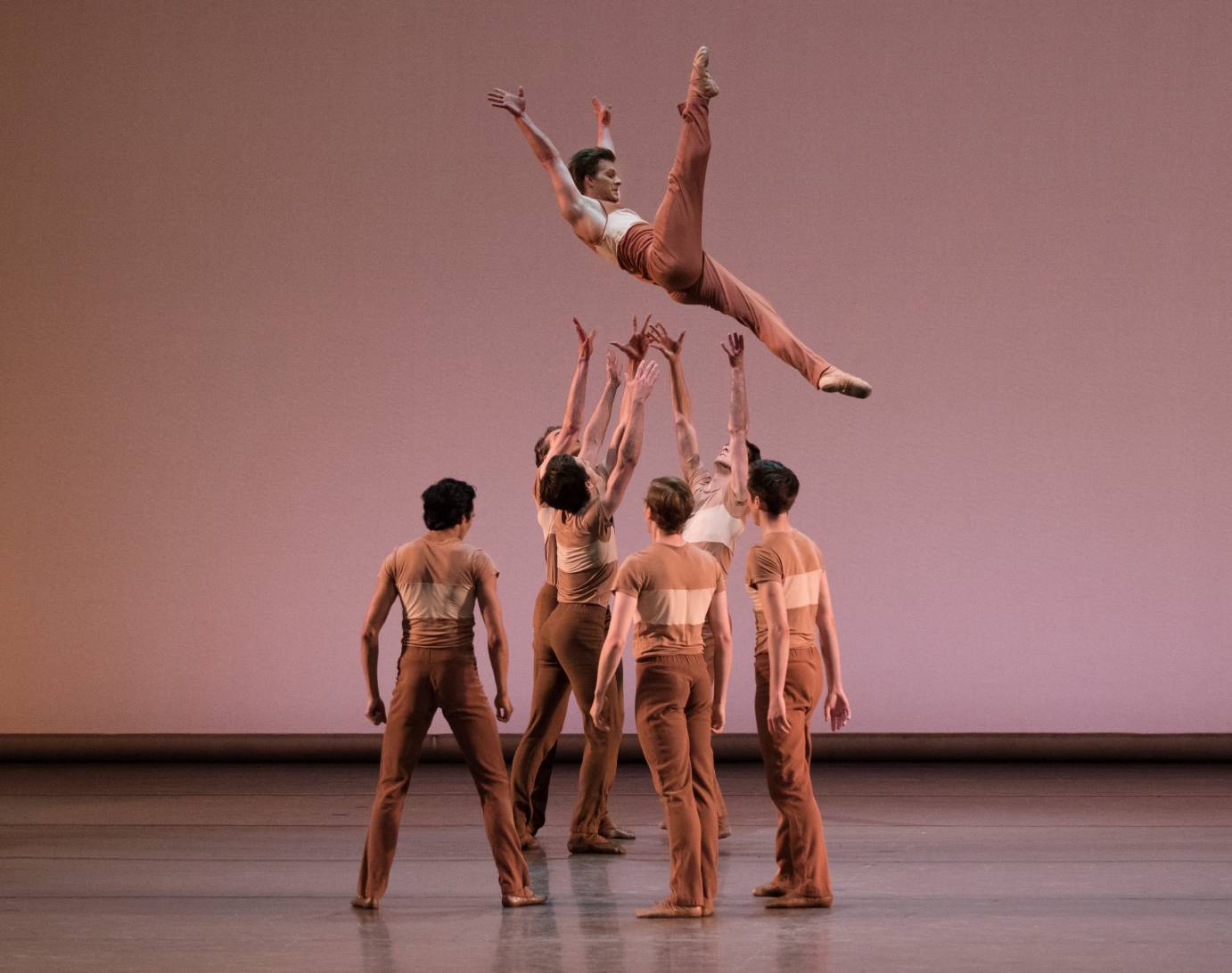 A group of men toss another man high in the air