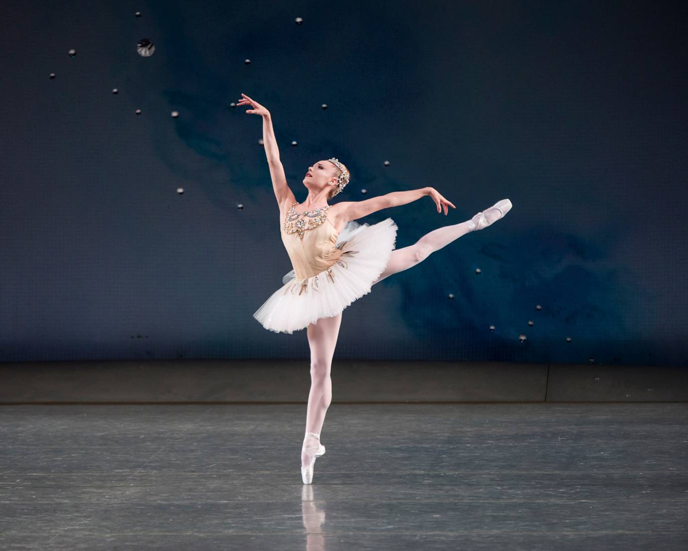 Sara Mearns wears a white tutu as she balances in arabesque