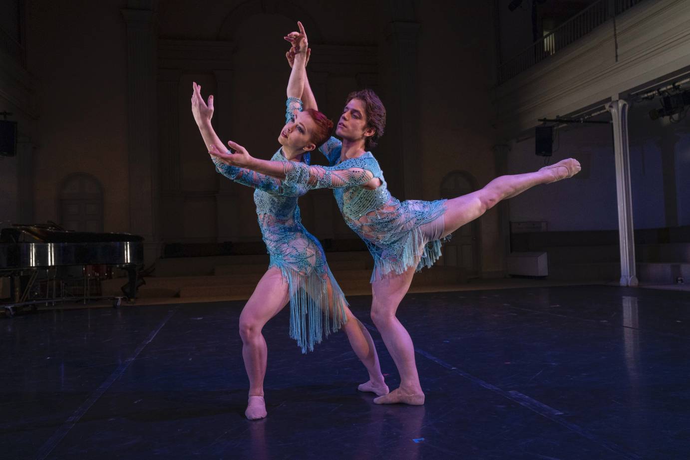 A woman lunges forward as a man leans in arabesque behind her