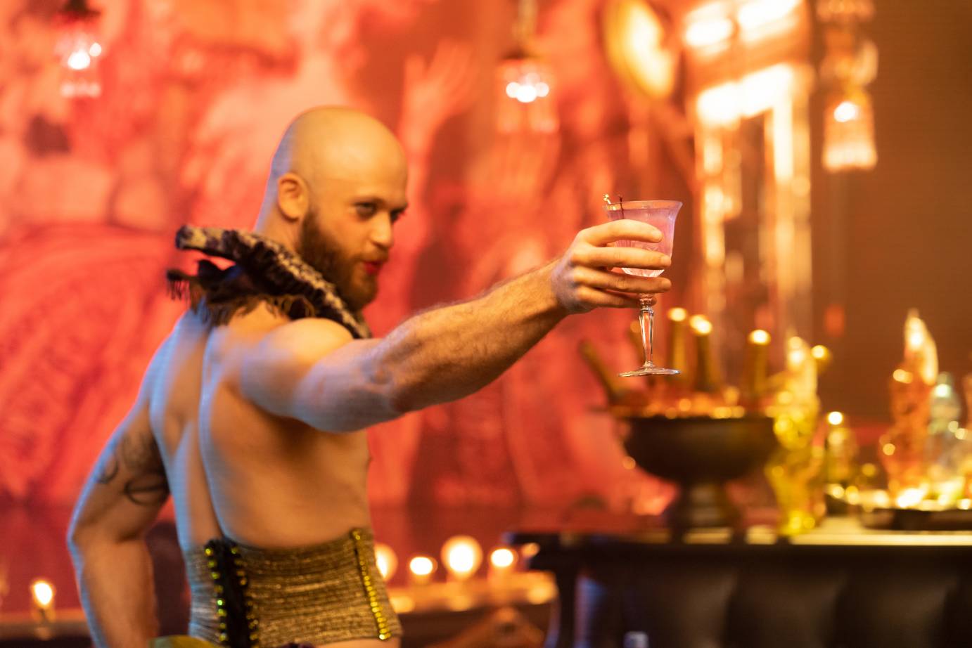 Bartender Sam Urdang cheers with a Candied Violet cocktail