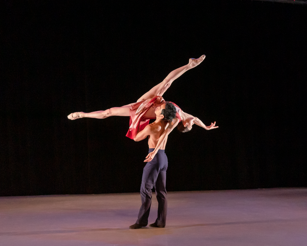 Jared Palazo lifts Emily Crone on to his shoulder as her legs splay into a wide split 