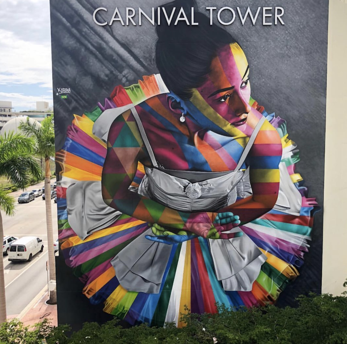 A mural of a young dancer painted with rainbows