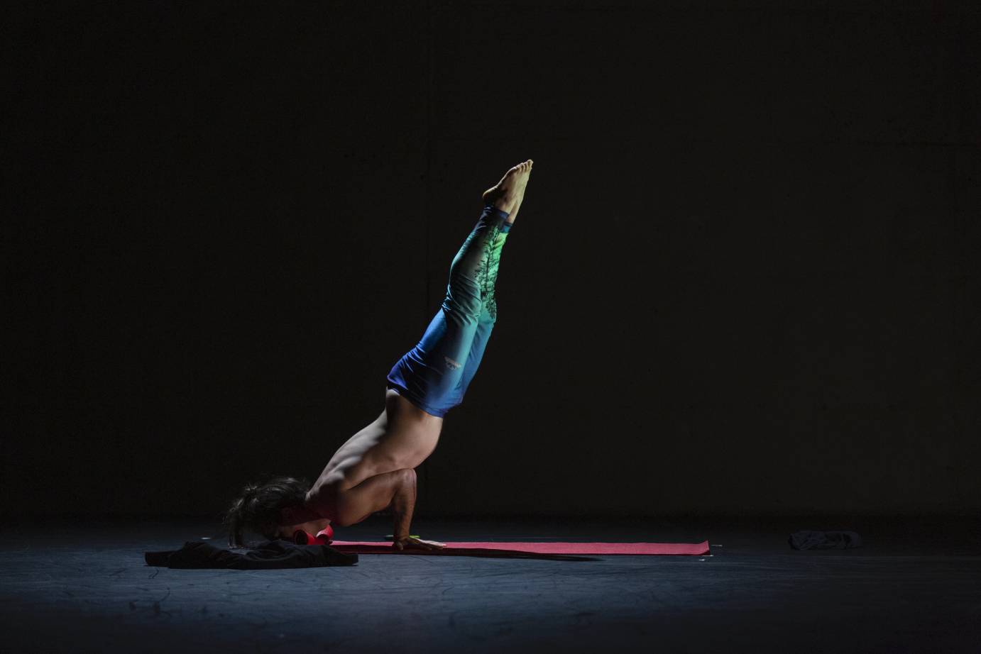 Collin Kelly performs a yogic handstand